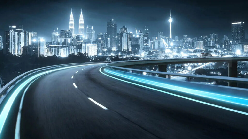 Curving highway with blue-lit guardrails leading towards an illuminated cityscape with numerous skyscrapers, including a pair of prominent twin towers, showcasing the impact of Microsoft Copilot Studio AI for Financial Services.