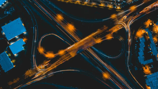 City intersection at night seen from above, symbolizing AI legislation and implementation.