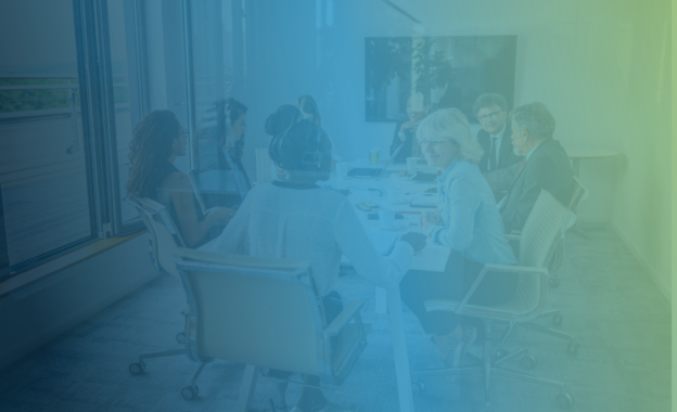 A group of professionals sits around a table.